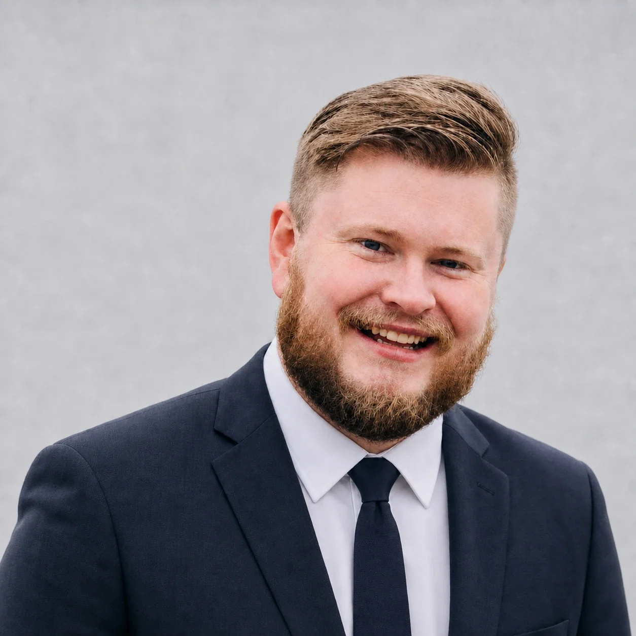 Tyler Barton, founder of Monastic Marketing, in a navy suit and tie
